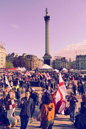 LONDON, UK - APRIL 23, 2016: Tourists visit Trafalgar Square for Saint George's Day in London, UK. Saint George is the patron saint of England.のeditorial素材