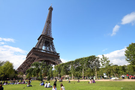 PARIS, FRANCE - JULY 21, 2011: People rest in front of Eiffel Tower in Paris, France. Eiffel Tower was the tallest building in the world from 1889 to 1930. It is a major landmark in Paris.のeditorial素材
