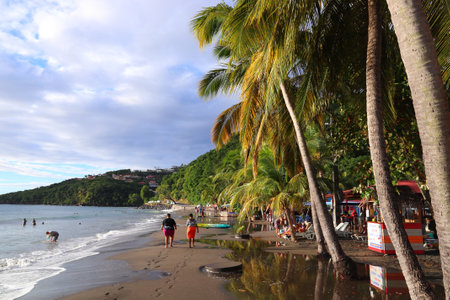 GUADELOUPE, FRANCE - DECEMBER 1, 2019: People spend beach vacation in Malendure Beach of Bouillante on Guadeloupe island. Guadeloupe has 650,000 annual visitors.のeditorial素材