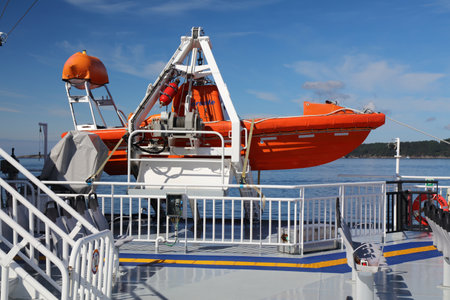 BJORNAFJORD, NORWAY - JULY 23, 2020: Lifeboat on a car ferry crossing Bjornafjord in Norway. Public transport by ferry carries more than 8 million passengers annually.のeditorial素材