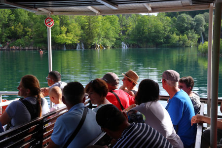 PLITVICE, CROATIA - JUNE 15, 2019: People take part in boat tour of Plitvice Lakes National Park (Plitvicka Jezera) in Croatia. Plitvice is the most popular national park in Croatia with 1.7 million visitors in 2017.のeditorial素材