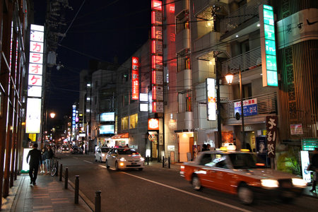 KYOTO, JAPAN - APRIL 14, 2012: People visit night streets of Kyoto city, Japan. Kyoto was visited by 15.6 million foreign tourists in 2017.のeditorial素材