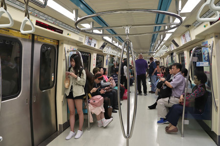 TAIPEI, TAIWAN - DECEMBER 3, 2018: People ride a Metro train in Taipei. Taipei Mass Rapid Transit (MRT) branded as Taipei Metro serves 746 million annual rides.のeditorial素材