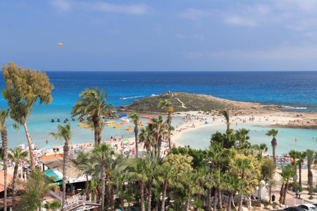 NISSI BEACH, CYPRUS - MAY 16, 2014: People visit Nissi Beach in Cyprus. Tourism makes about 10 percent of Cyprus budget with 2.4 million annual arrivals (2011).のeditorial素材
