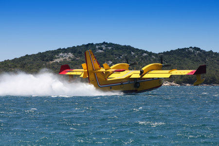 SIBENIK, CROATIA - JUNE 25, 2011: Bombardier CL-415 water bomber aircraft near Sibenik, Croatia. CL-415 and similar water bomber fire fighting aircraft are used in Croatia during summer to put out forest fires.のeditorial素材