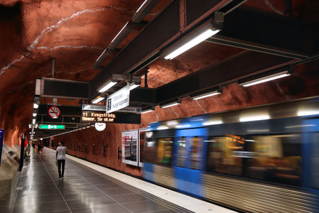 STOCKHOLM, SWEDEN - AUGUST 24, 2018: People ride Stockholm metro (T-bana) in Sweden. Stockholm metro is known for its artistic station interiors.のeditorial素材