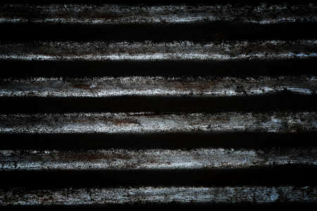 Dark distressed metal texture. Black grungy metal background.の写真素材