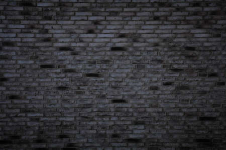Dark brick wall background. Gray bricks texture. Building side.の写真素材
