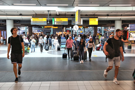 AMSTERDAM, NETHERLANDS - JULY 7, 2017: Travelers visit Schiphol Airport in Amsterdam. Schiphol is the 12th busiest airport in the world.のeditorial素材