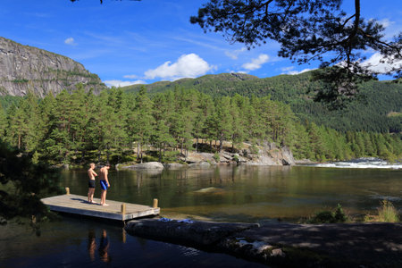 SETESDAL, NORWAY - JULY 31, 2020: People visit swimming area of River Otra in Setesdal valley, Norway. Norway had 8.8 million foreign visitors in 2015.のeditorial素材