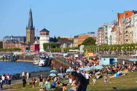 DUSSELDORF, GERMANY - SEPTEMBER 19, 2020: People visit river Rhine waterfront in Dusseldorf, Germany. Dusseldorf is the 7th largest city in Germany by population.のeditorial素材