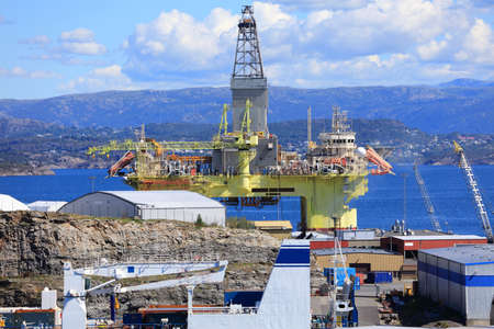 Offshore drilling rig maintenance in a fiord near Bergen, Norway. Oil industry structure.