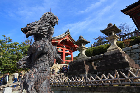 KYOTO, JAPAN - NOVEMBER 26, 2016: People walk by dragon sculpture and bell tower at Kiyomizu Dera Temple in Kyoto, Japan. Kyoto has 17 UNESCO World Heritage Sites.のeditorial素材