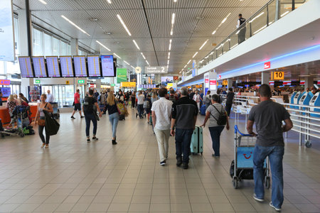 AMSTERDAM, NETHERLANDS - JULY 11, 2017: Travelers visit Schiphol Airport in Amsterdam. Schiphol is the 12th busiest airport in the world with more than 63 million annual passengers.のeditorial素材