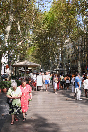 BARCELONA, SPAIN - SEPTEMBER 13, 2009: People walk famous Rambla avenue in Barcelona, Spain....