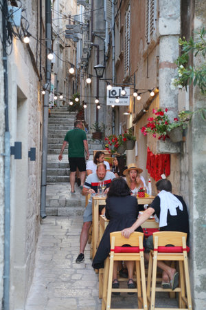 KORCULA, CROATIA - JUNE 16, 2021: People eat at local restaurants of Medieval Korcula Town in summertime Croatia.のeditorial素材