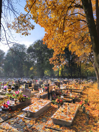 BYTOM, POLAND - OCTOBER 25, 2020: Autumn view of graves and candles at a cemetery during week before All Saints Day (Wszystkich Swietych) in Poland.のeditorial素材