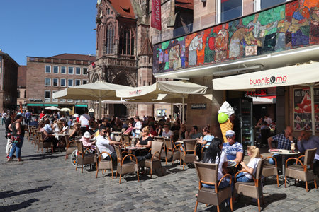 NUREMBERG, GERMANY - MAY 6, 2018: People visit a cafe in the main square Hauptmarkt in Nuremberg, Germany. Nuremberg is located in Middle Franconia. 511,628 people live here.のeditorial素材