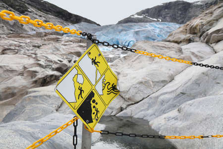 Norway nature. Glacier dangers warning next to hiking trail. Jostedalsbreen National Park - Nigardsbreen Glacier.の写真素材