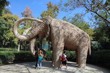BARCELONA, SPAIN - OCTOBER 7, 2021: People visit the mammoth statue in Parc de la Ciutadella in Barcelona, Spain.のeditorial素材