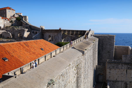 DUBROVNIK, CROATIA - JULY 18, 2021: Tourists visit medieval Dubrovnik Old Town city walls, a UNESCO World Heritage Site.のeditorial素材