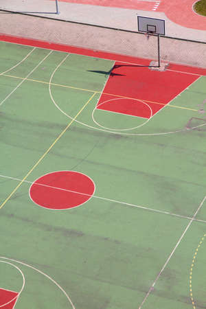 School basketball court with green and red surface. Outdoor basketball court in Poland.の写真素材