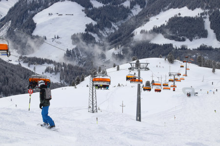 ZELL AM ZILLER, AUSTRIA - MARCH 14, 2019: People visit Zell Am Ziller ski resort in Tyrol region, Austria. The resort is located in Zillertal valley of Central Eastern Alps (Zentralalpen).のeditorial素材