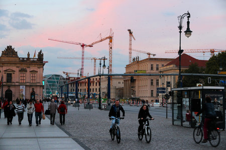 BERLIN, GERMANY - AUGUST 26, 2014: People walk in evening Berlin, with Berlin Palace reconstruction works in background.のeditorial素材