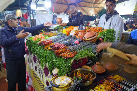 MARRAKECH, MOROCCO - FEBRUARY 20, 2022: Food vendors at Jemaa el-Fnaa square market of Marrakech. The square is listed as UNESCO Masterpiece of Intangible Heritage of Humanity.のeditorial素材