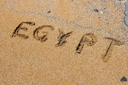 Finger drawing on a sandy beach - Egypt word.の写真素材