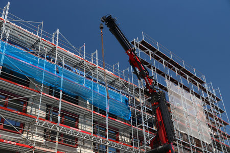 NUREMBERG, GERMANY - MAY 7, 2018: Construction site in downtown Nuremberg, Germany. The massive loading crane is Palfinger model PK 20000 2L.のeditorial素材