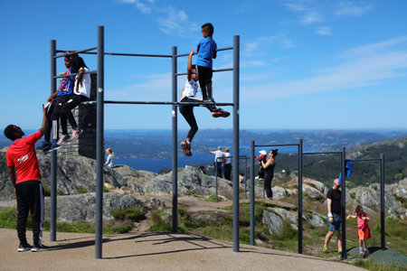 BERGEN, NORWAY - JULY 23, 2020: People use public fitness exercise equipment at Ulriken mountain overlooking city of Bergen, Norway.のeditorial素材