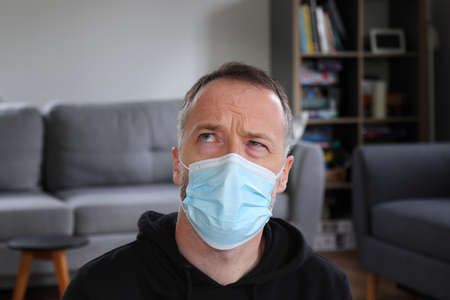 Man thinking. Concentrated person doing heavy thinking in face mask. Bearded man wearing casual...