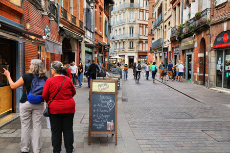 TOULOUSE, FRANCE - SEPTEMBER 28, 2021: People visit downtown Toulouse city, Capitole district. Toulouse is the 4th largest commune in France.のeditorial素材