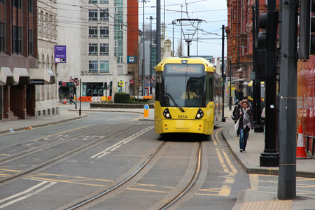 MANCHESTER, UK - APRIL 21, 2013: People ride Manchester tram in Manchester, UK. Manchester Metrolink serves 21 million rides annually (2011).のeditorial素材