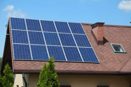 Solar panels on generic house roof. Photovoltaic energy generation near Bielsko-Biala, Poland.