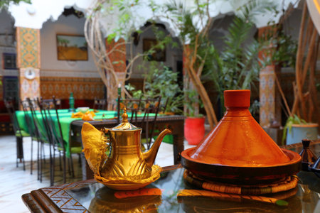 Moroccan teapot and traditional tagine cooking dish in a hotel in Morocco.の写真素材