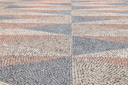 Stone paved square background - ornamental cobblestone pattern in Belem district of Lisbon city, Portugal.の写真素材
