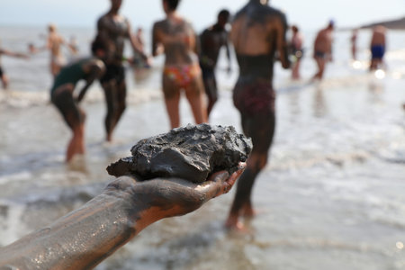 Dead Sea mud in Israel. Dead Sea mud handful. It has medicinal properties and is used in skin care cosmetics.の写真素材