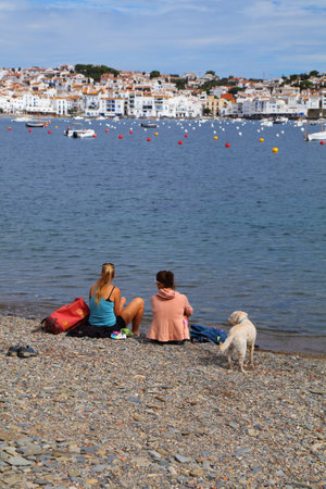 CADAQUES, SPAIN - OCTOBER 5, 2021: People visit picturesque fishing harbor of Cadaques in Catalonia region of Spain. The town is located in Alt Emporda county of Catalonia, Spain.のeditorial素材