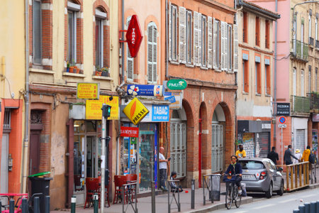 TOULOUSE, FRANCE - SEPTEMBER 28, 2021: People visit Toulouse city, St-Cyprien district. Toulouse is...
