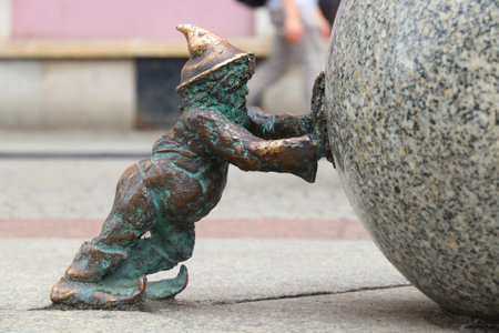 WROCLAW, POLAND - MAY 11, 2018: Sisyphus gnome or dwarf small statues in Wroclaw, Poland. Wroclaw has 350 gnome sculptures around the city.のeditorial素材