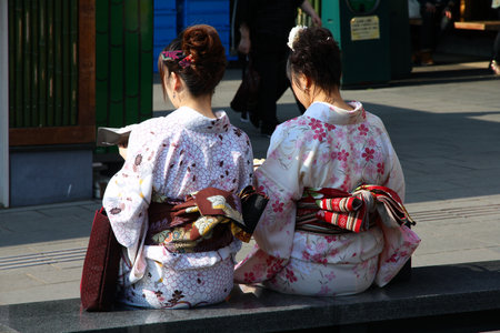 KYOTO, JAPAN - APRIL 17, 2012: Women in traditional kimono costumes visit Arashiyama in Kyoto, Japan. Arashiyama is a nationally-designated Place of Scenic Beauty and Historic Site.のeditorial素材