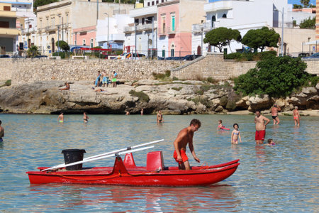 APULIA, ITALY - MAY 30, 2017: Beachgoers visit Santa Maria Al Bagno beach in Puglia region, Italy. With 50.7 million annual visitors Italy is one of the most visited countries.のeditorial素材