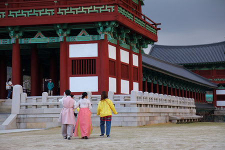 GYEONGJU, SOUTH KOREA - MARCH 26, 2023: Tourists in traditional hanbok clothes visit historic sites of Gyeongju, South Korea. Silkworm was an important decoration motif in historic Gyeongju.のeditorial素材