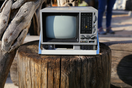 Vintage portable mini TV and radio. 1980s technology nostalgia small TV set.