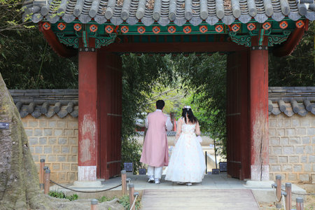JEONJU, SOUTH KOREA - APRIL 4, 2023: Tourists in traditional Korean hanbok clothing visit Gyeonggijeon shrine gardens in Jeonju.のeditorial素材