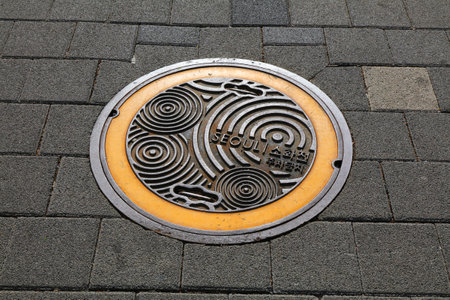 SEOUL, SOUTH KOREA - APRIL 7, 2023: Decorative cast iron manhole cover in Seoul, capital city of South Korea.のeditorial素材