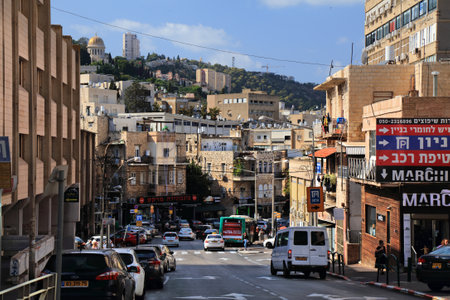 HAIFA, ISRAEL - OCTOBER 31, 2022: Street traffic in Lower City of Haifa, one of largest cities in Israel. Mount Carmel in background.のeditorial素材