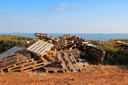 Wooden pallet pile. Standard transport pallet randomly dumped on a stack in Cyprus.
